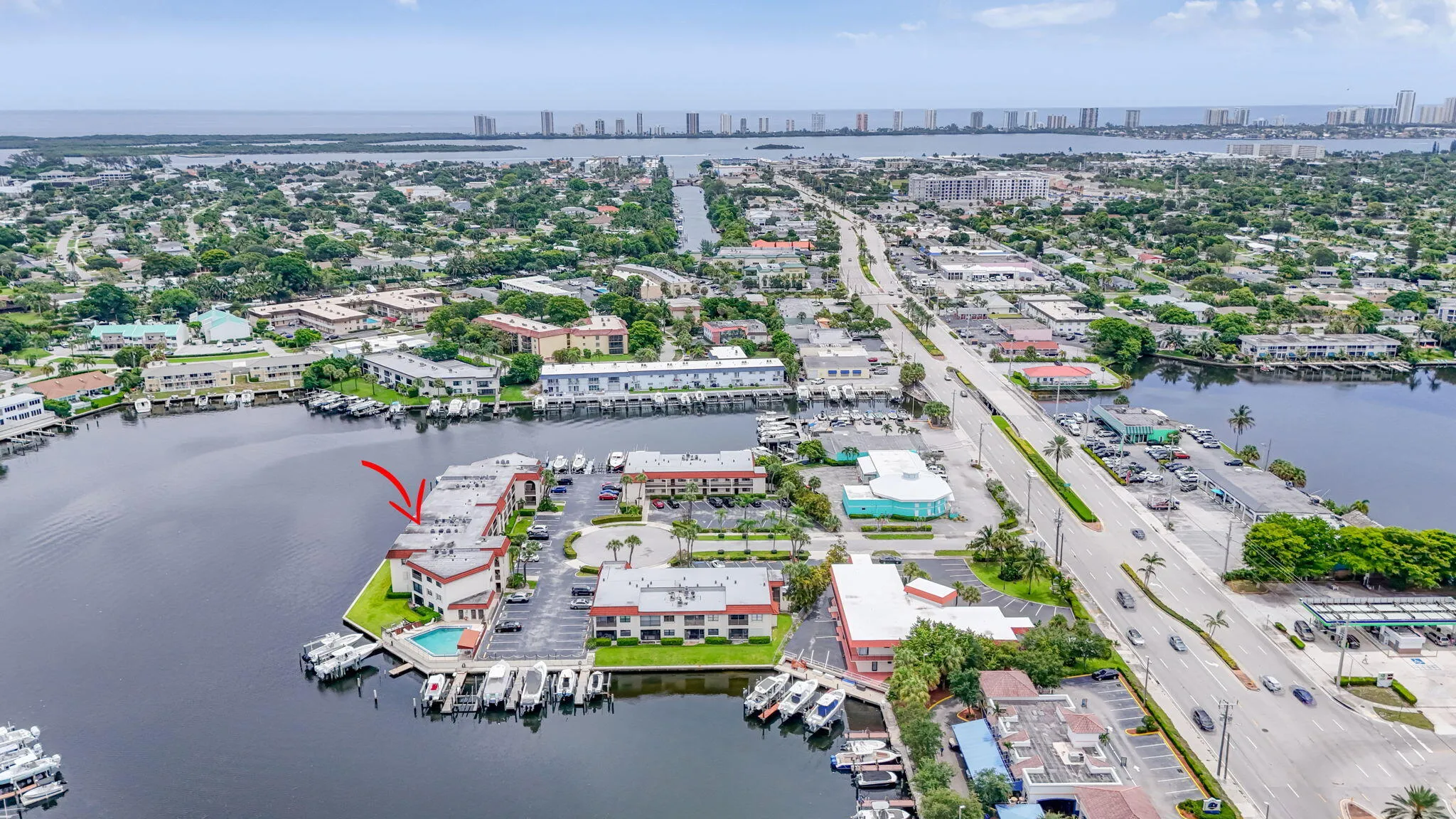Waterfront community with boat slips, residential units, and a central swimming pool