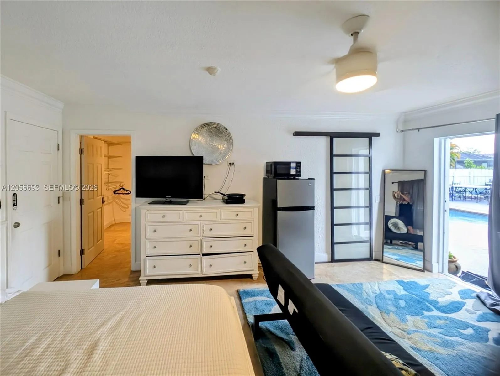 Walk in closet , dresser , tv, fridge, microwave, hot plate, Sliding door to bathroom