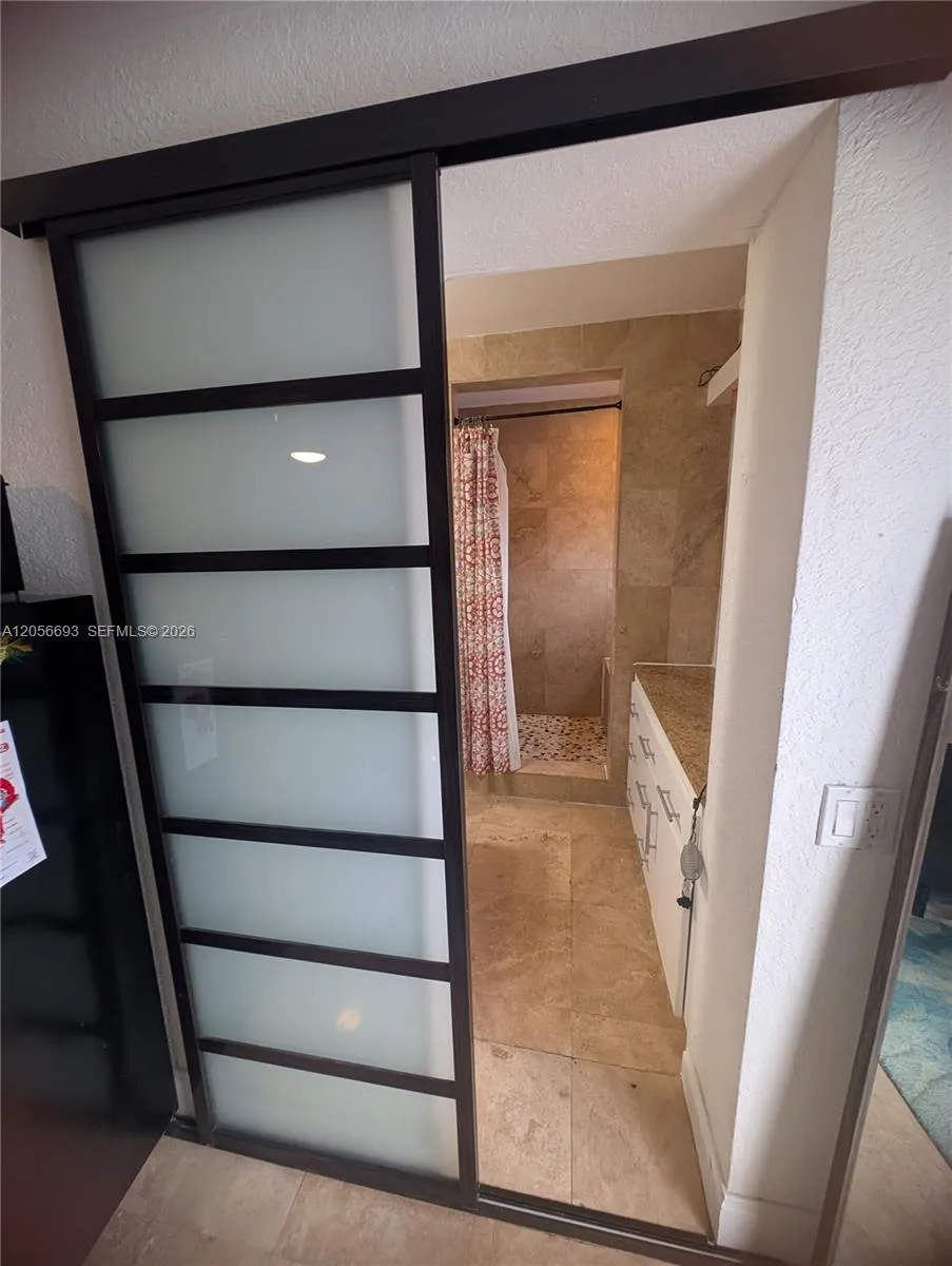 Sliding door to bathroom w/separate shower with seat