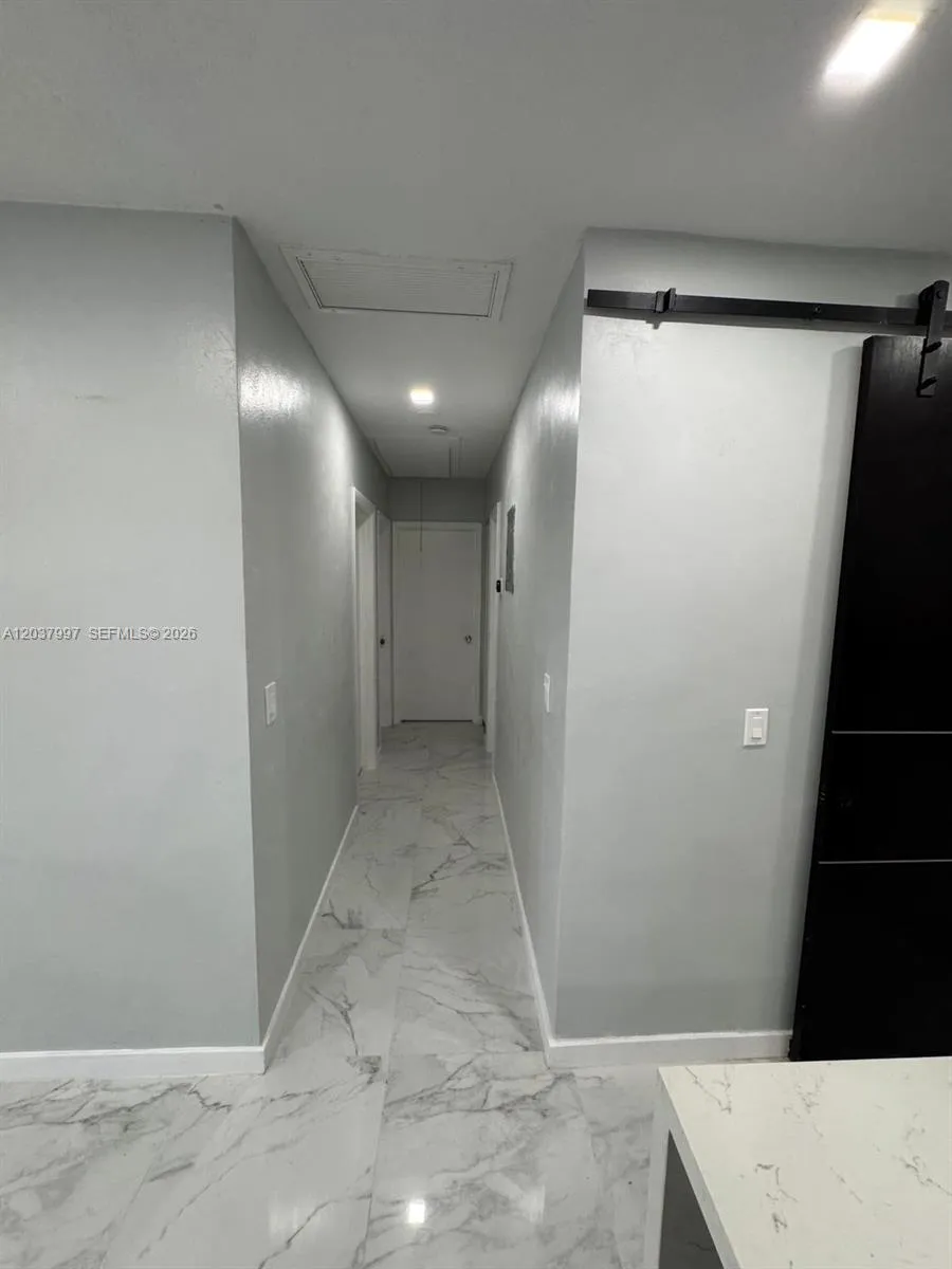 Hallway to rooms and bathroom