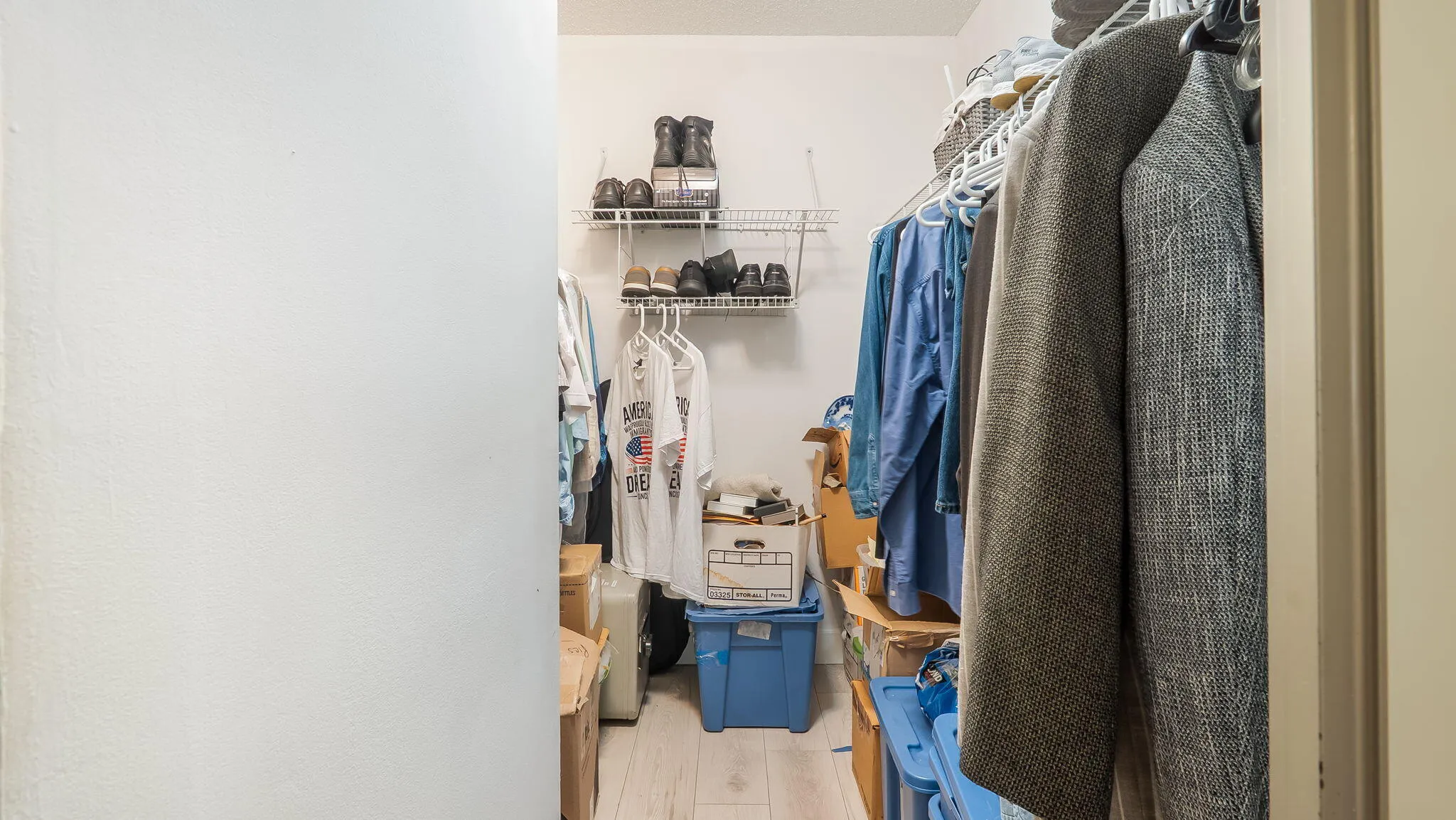 Walk-in closet featuring wire shelving and hanging rods