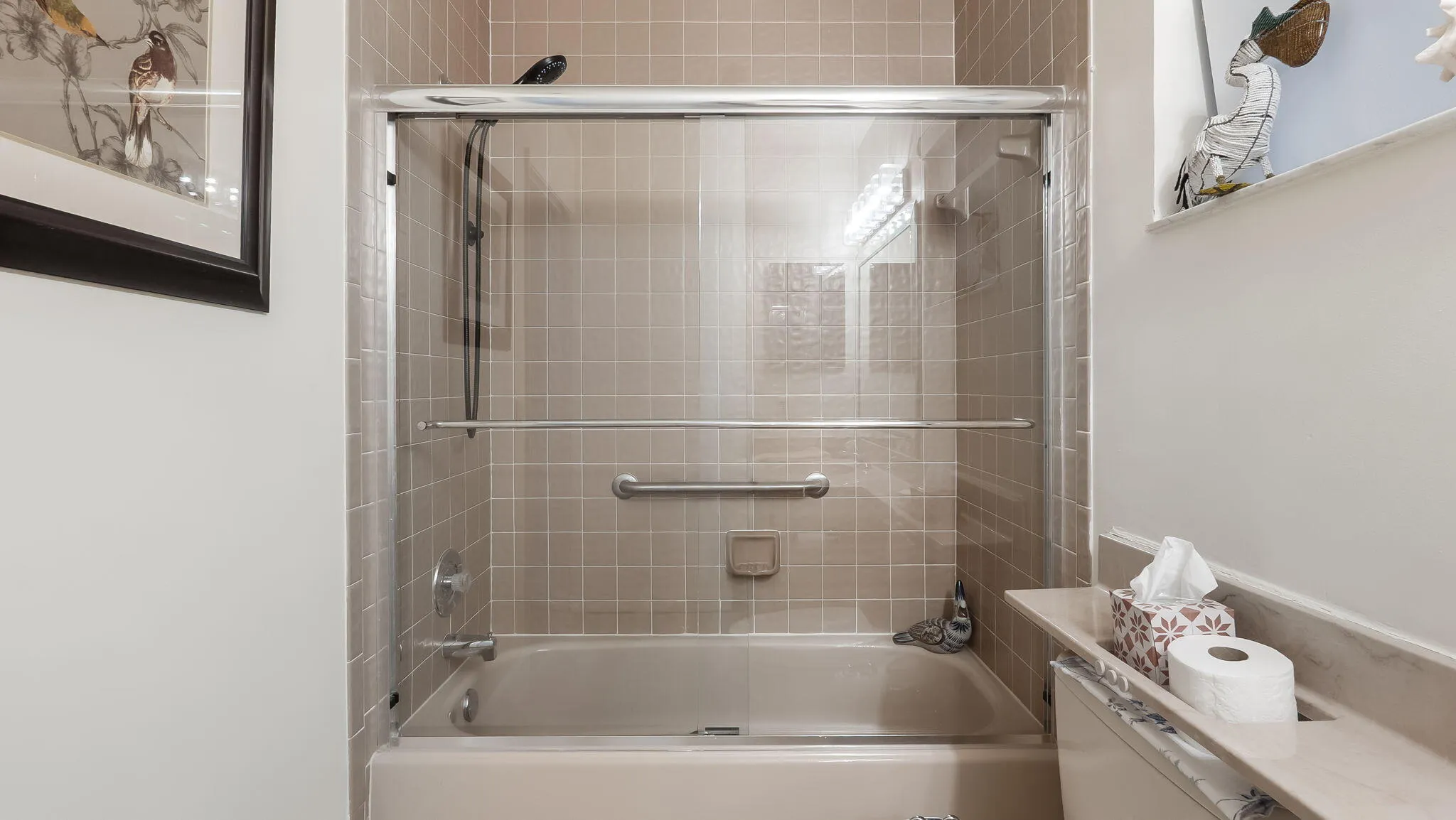 Bathtub with sliding glass enclosure and grab bar