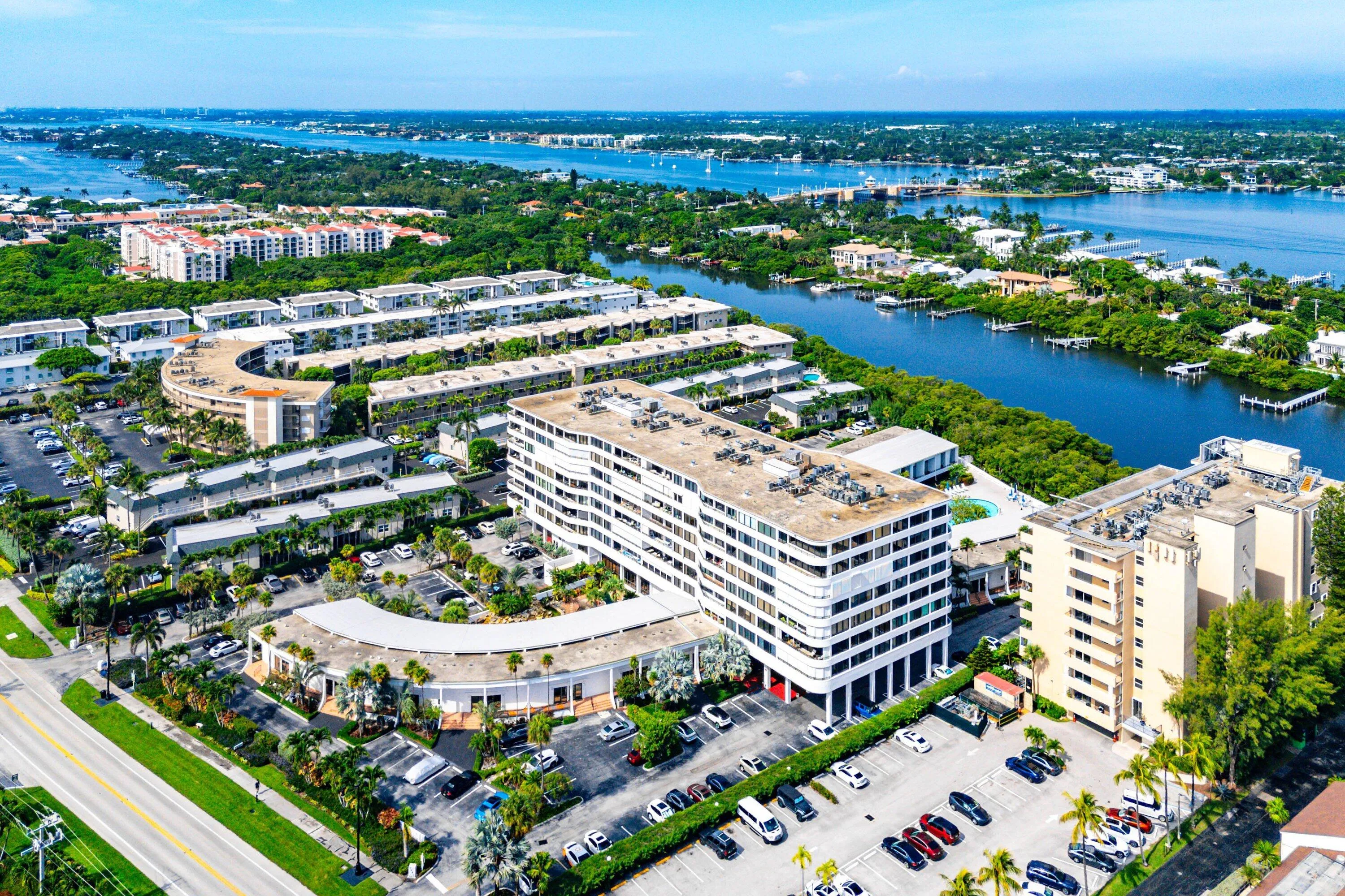 Aerial perspective showcasing a waterfront community with multiple residential buildings
