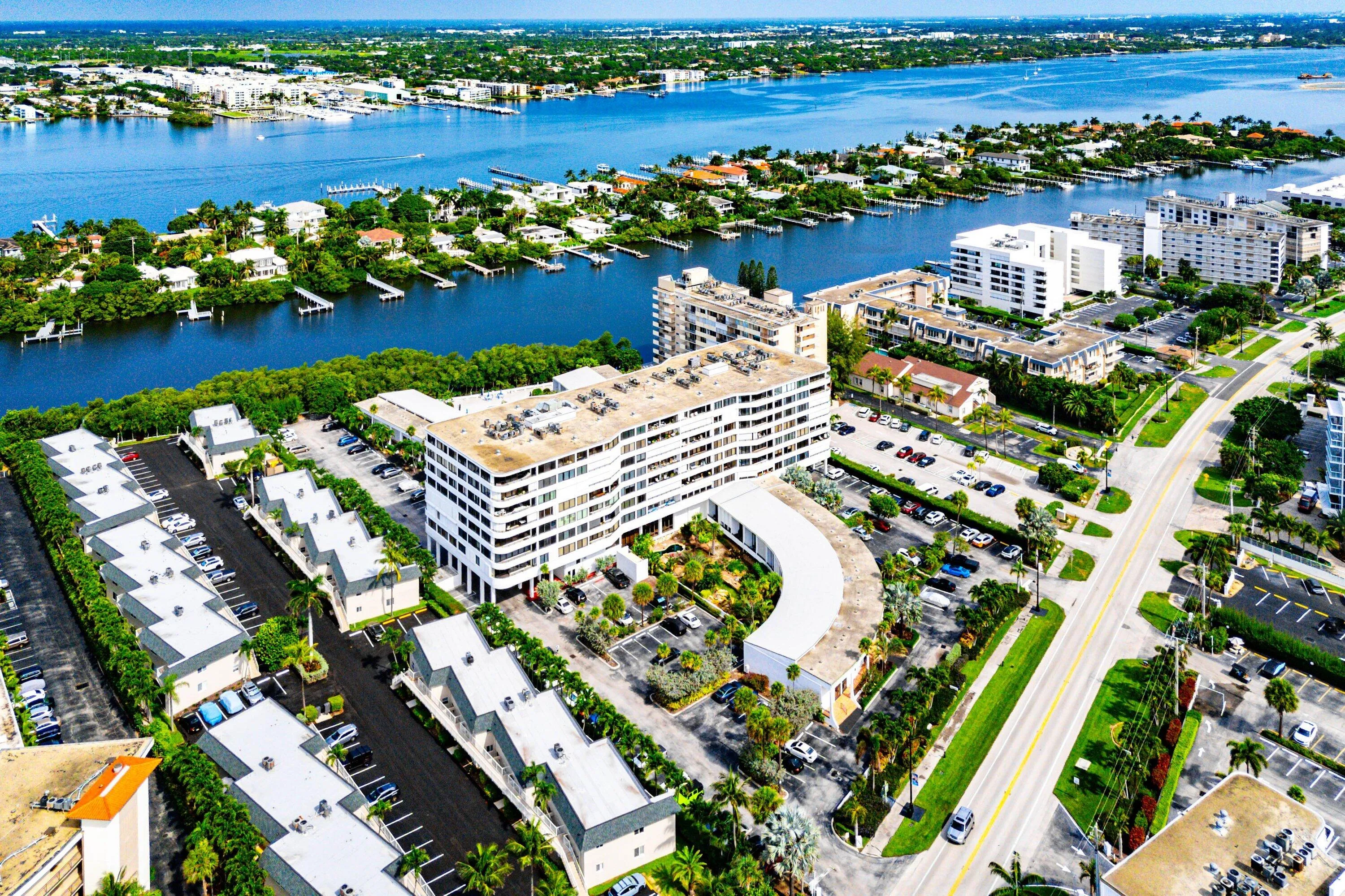 Aerial perspective showcasing waterfront properties and a multi-building complex