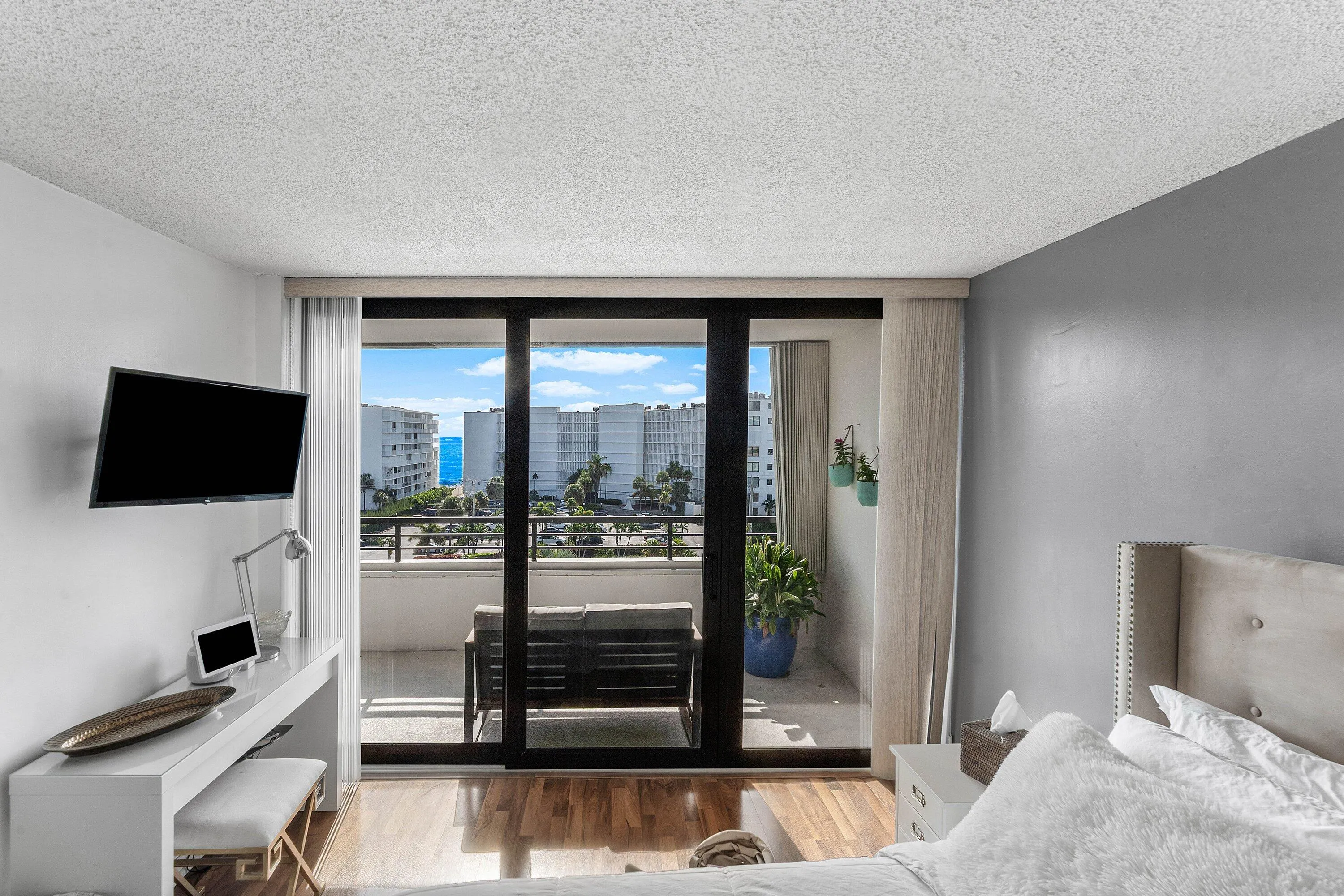 Room featuring wood-finish flooring and a private balcony with water scenery