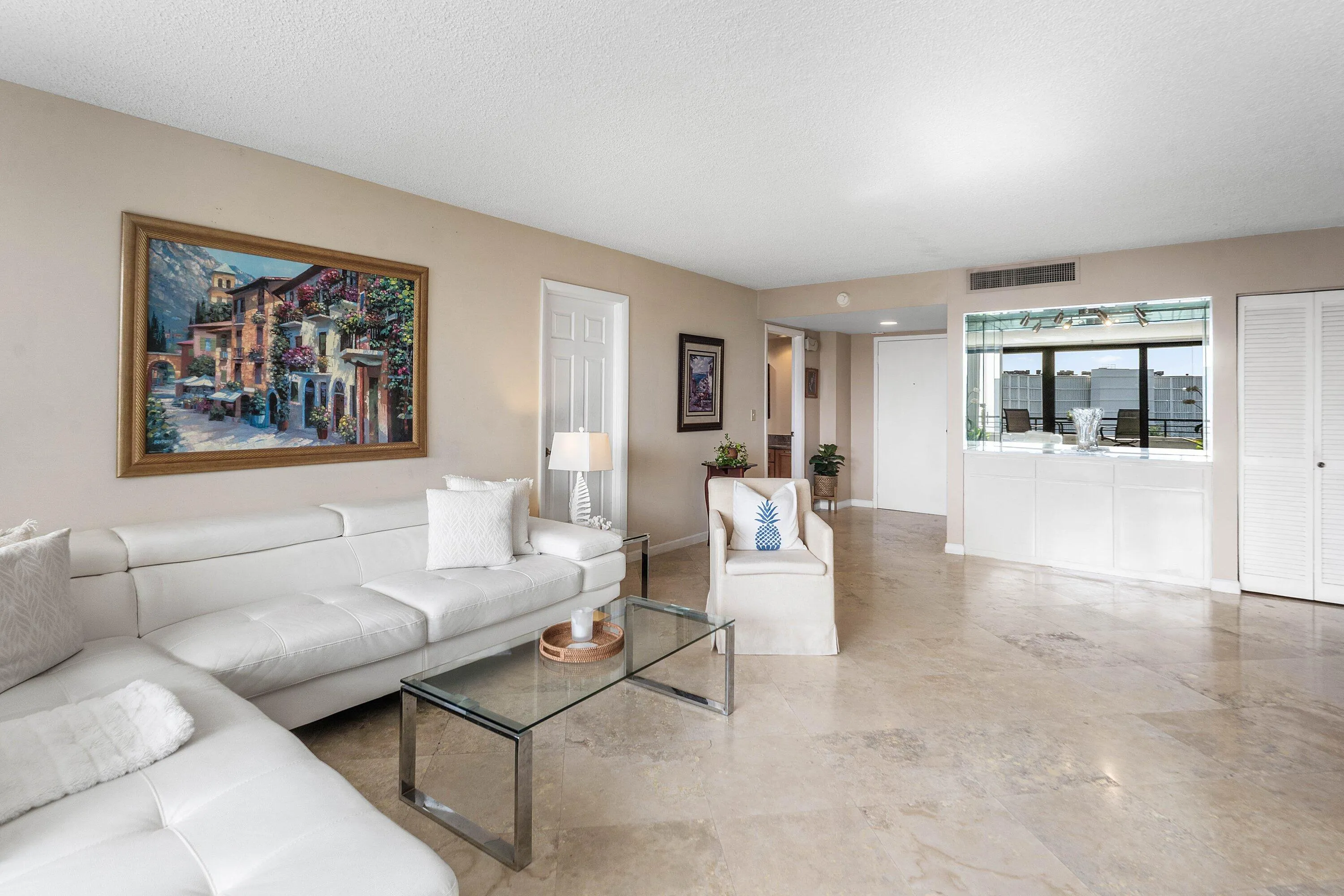 Spacious living area featuring light-toned flooring, recessed lighting, and neutral wall tones
