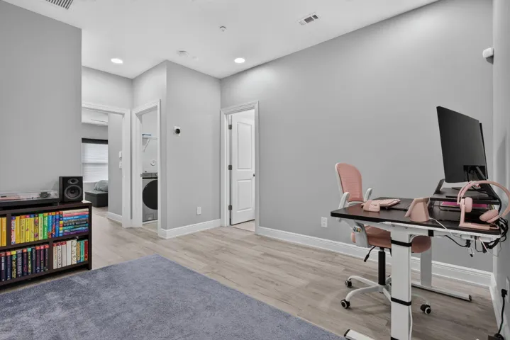 Loft featuring wood-finish flooring, recessed lighting, and light gray wall paint