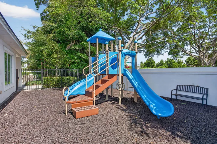 Outdoor play structure featuring multiple slides, stairs, and a platform