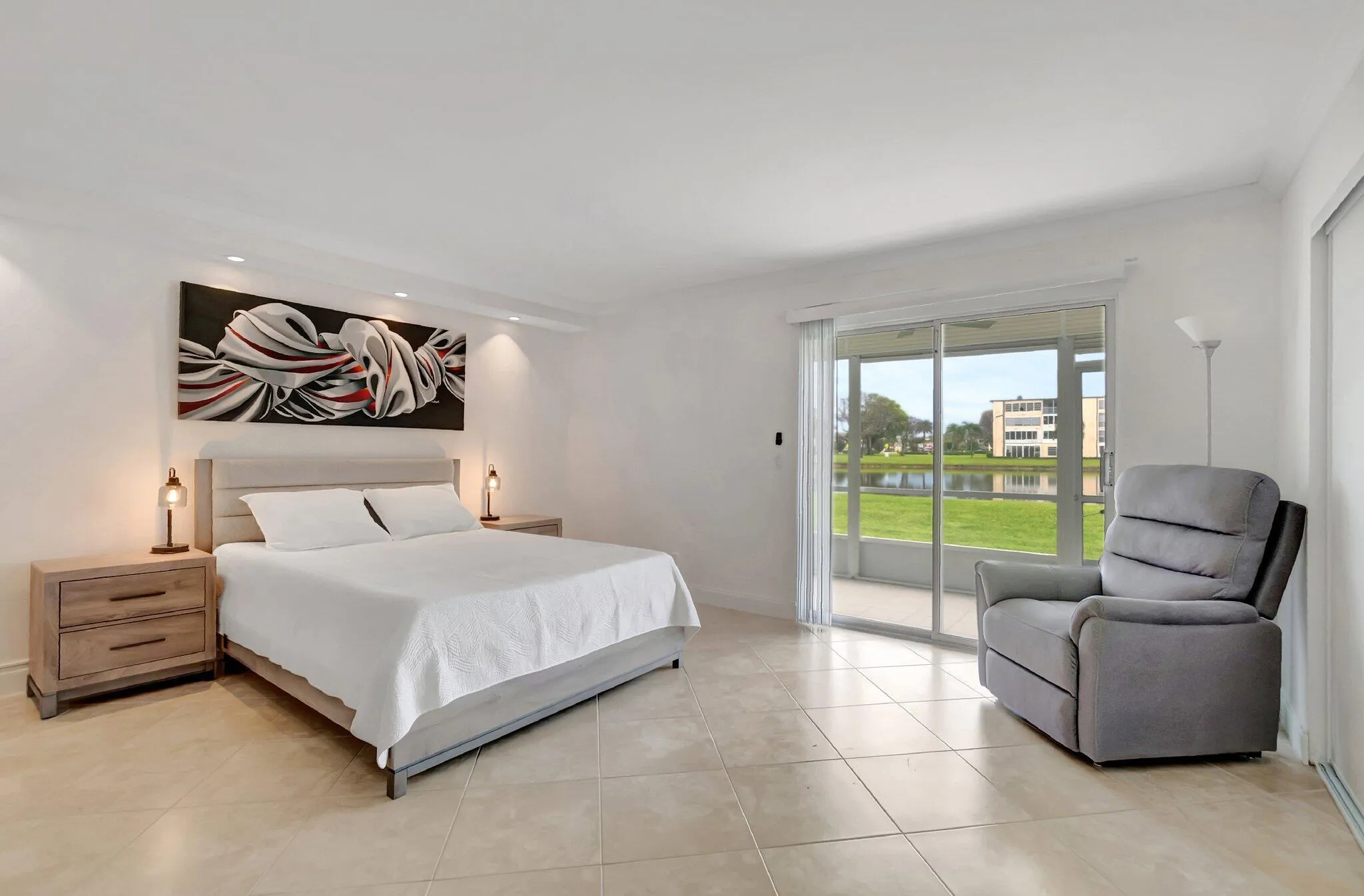 Bright interior featuring tile flooring, sliding glass doors, and recessed lighting