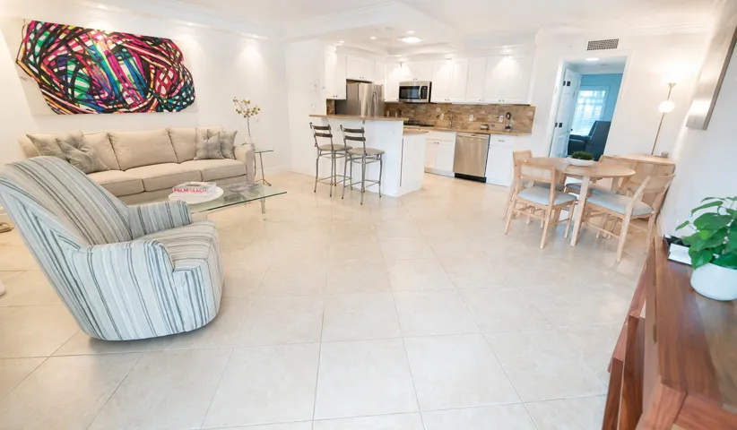 Kitchen featuring white cabinetry, stainless steel appliances, a tiled backsplash, and light-toned countertops