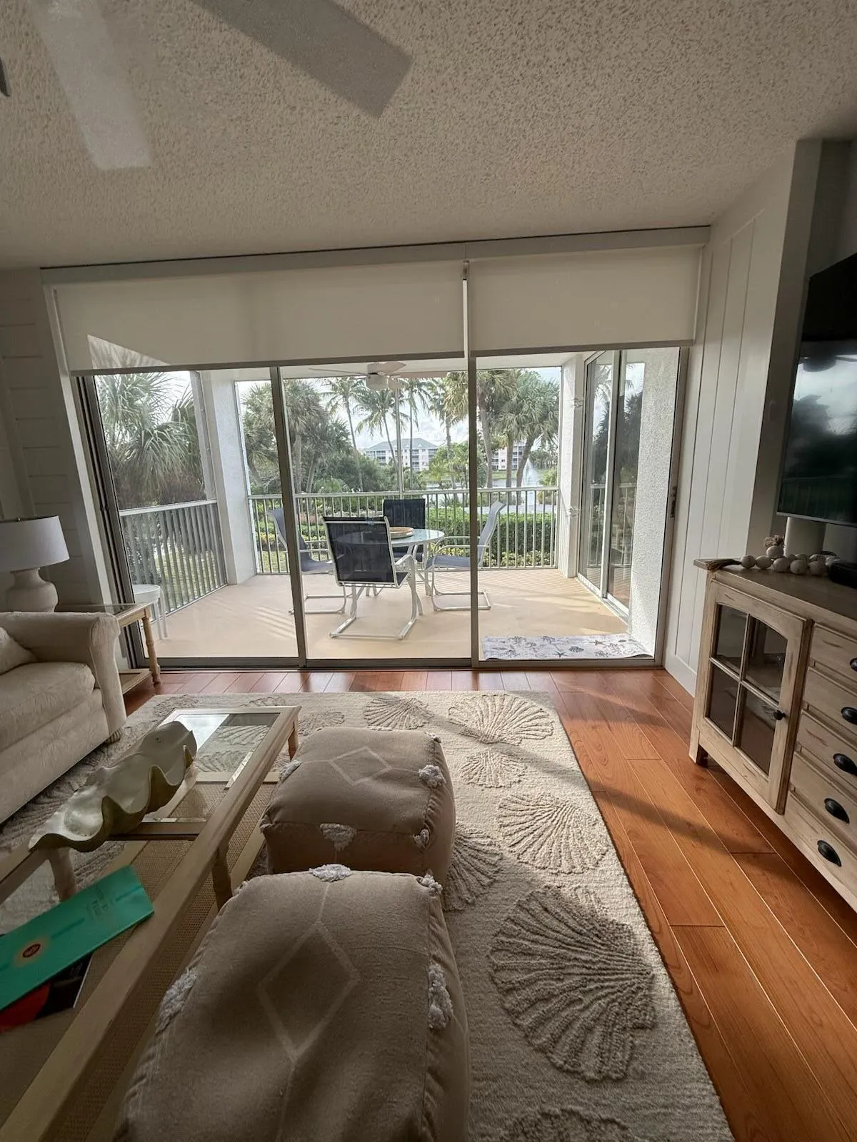 Spacious living area featuring expansive sliding glass doors opening to a private balcony