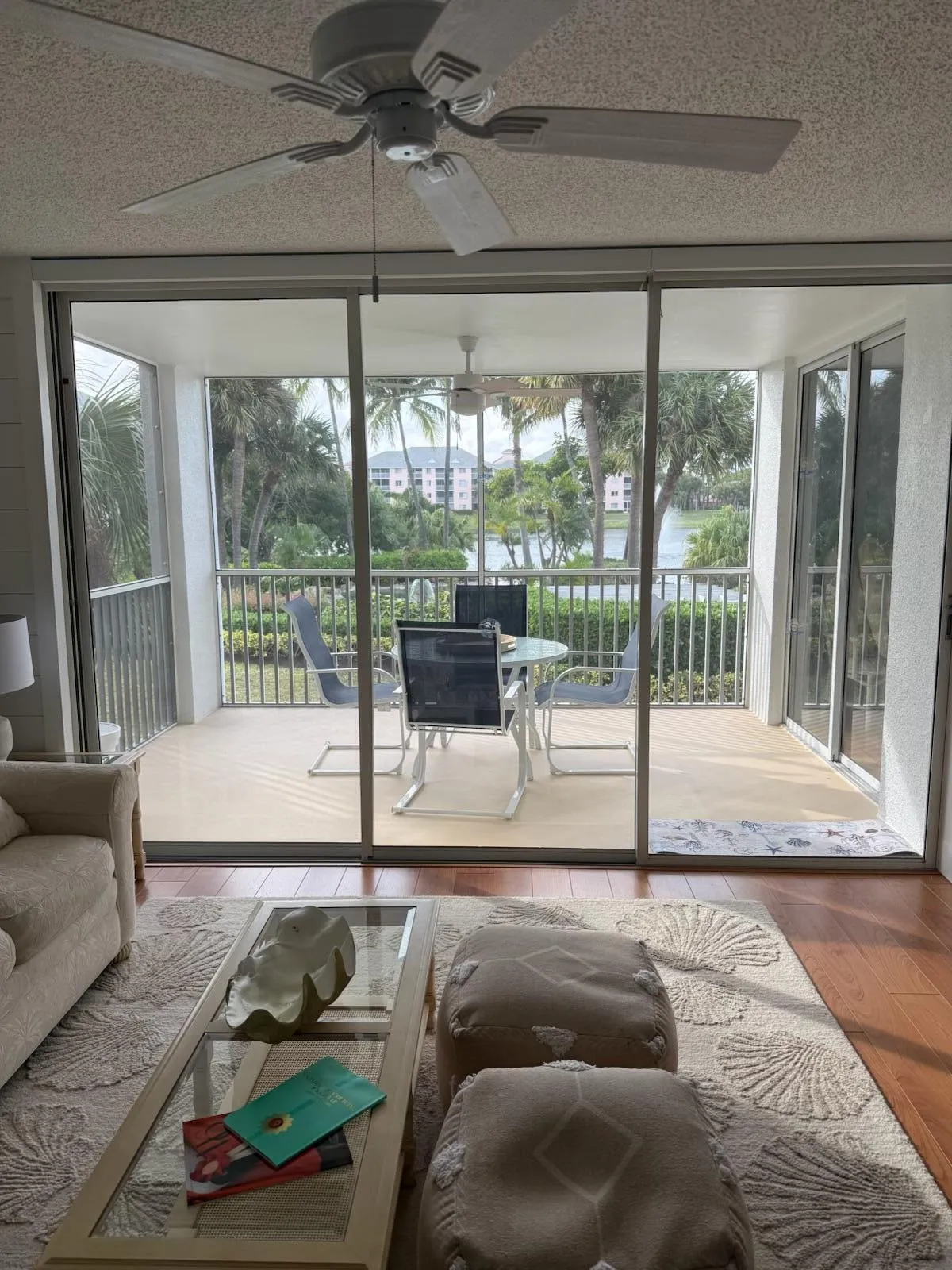 Expansive screened balcony with water views and tropical landscaping