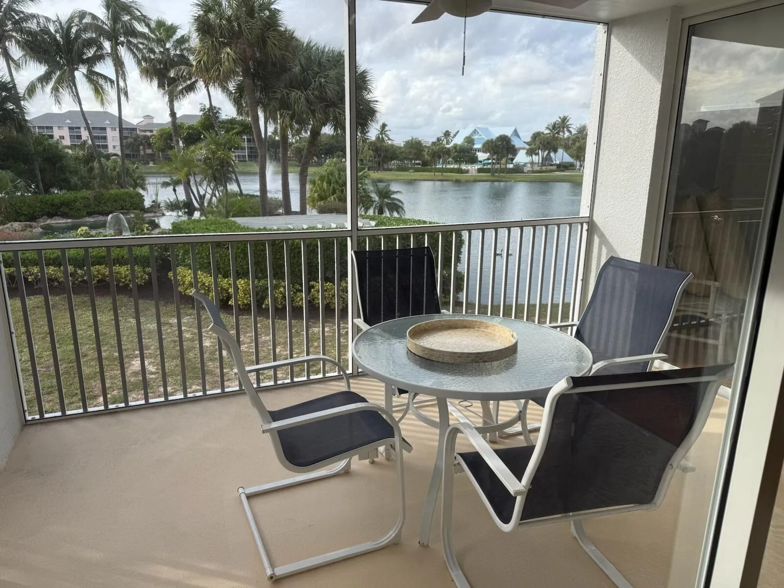 Screened balcony with lake frontage and tropical landscaping