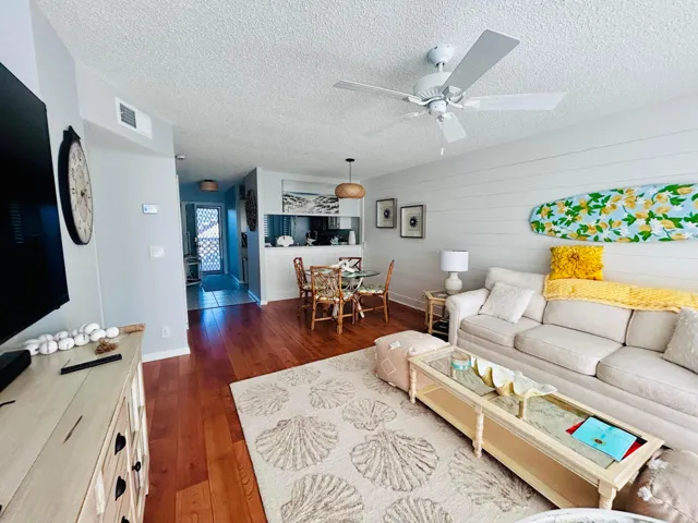 Open concept living area featuring wood-finish flooring