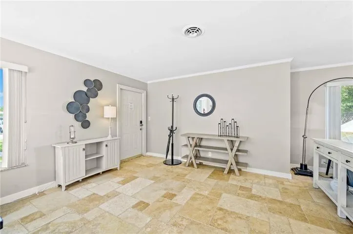 Entryway featuring large format tile flooring and light gray walls