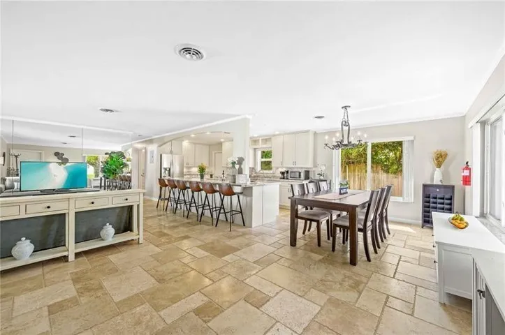 Spacious open-concept living area featuring large format tile flooring throughout