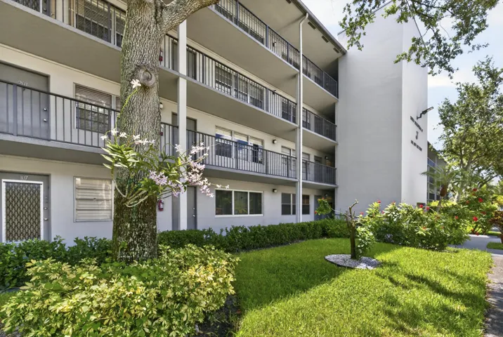 Building exterior featuring multiple levels of private balconies with black railings
