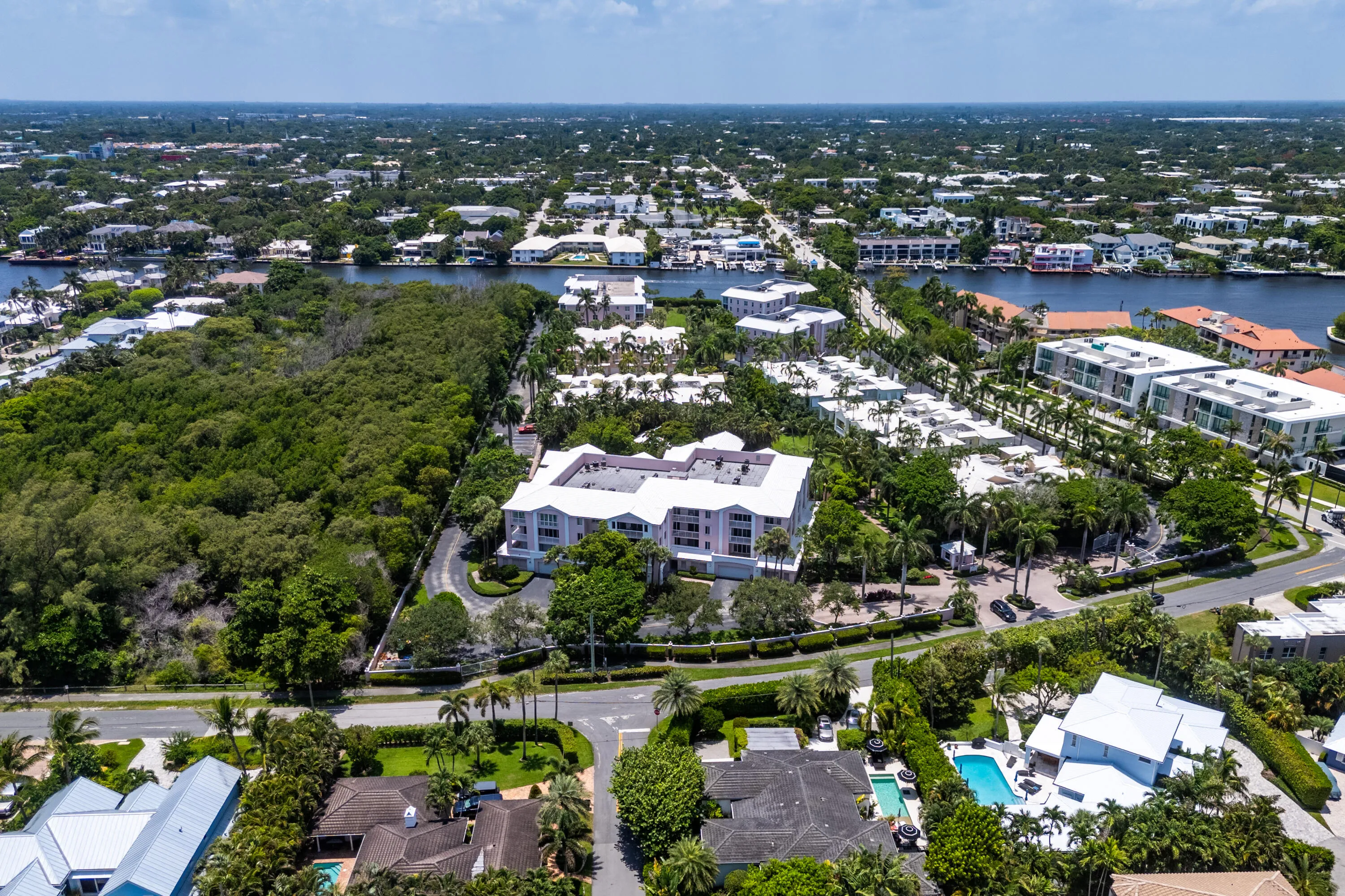Expansive aerial view showcasing waterfront properties and lush tropical landscaping