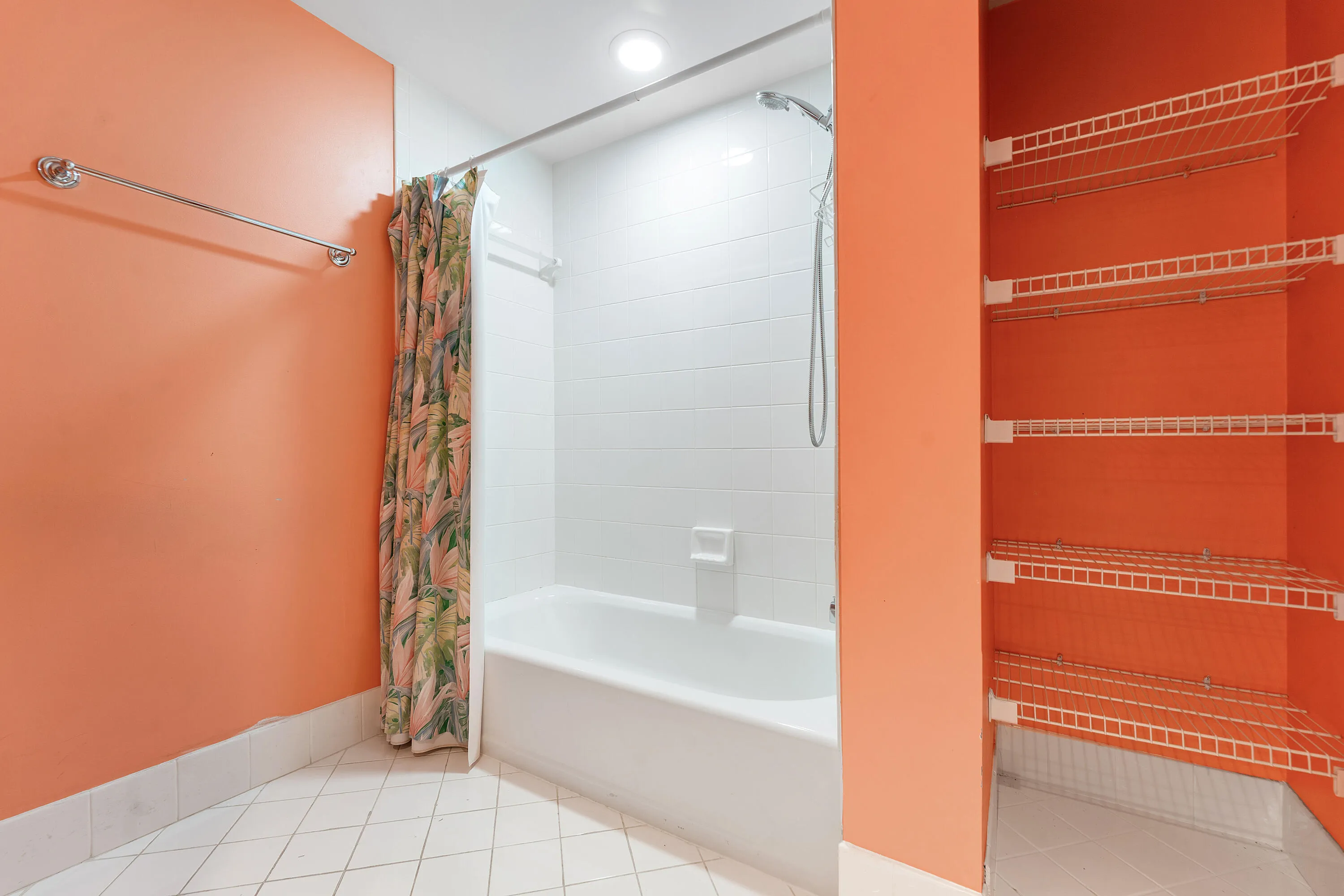 Bathroom featuring a full-size tub with shower, white subway tile surround, recessed lighting, and white tile flooring