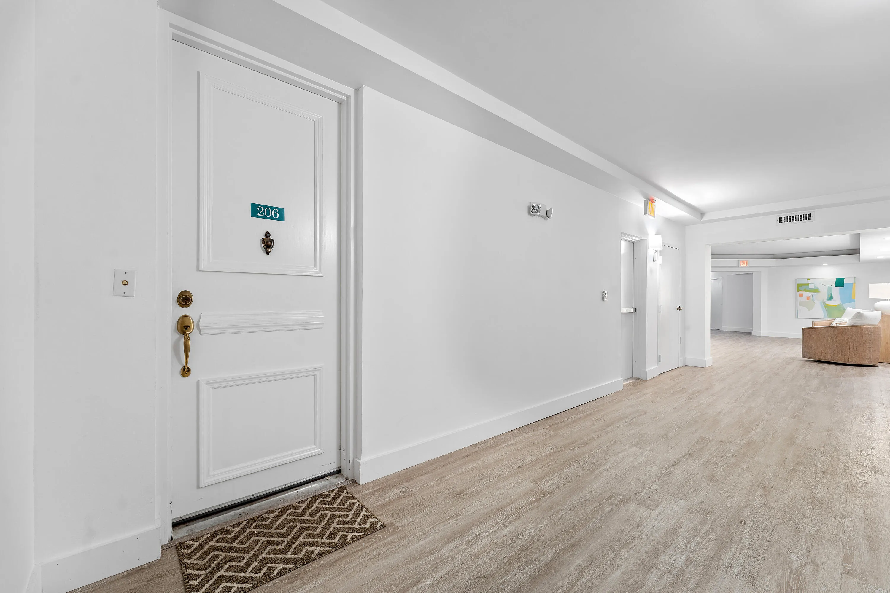 Entry door with paneled design and brass hardware