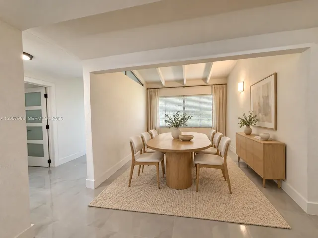 Recessed ceiling lighting, exposed ceiling beams, wall-mounted light fixture, light wood-finish flooring, and a window with blinds and curtains