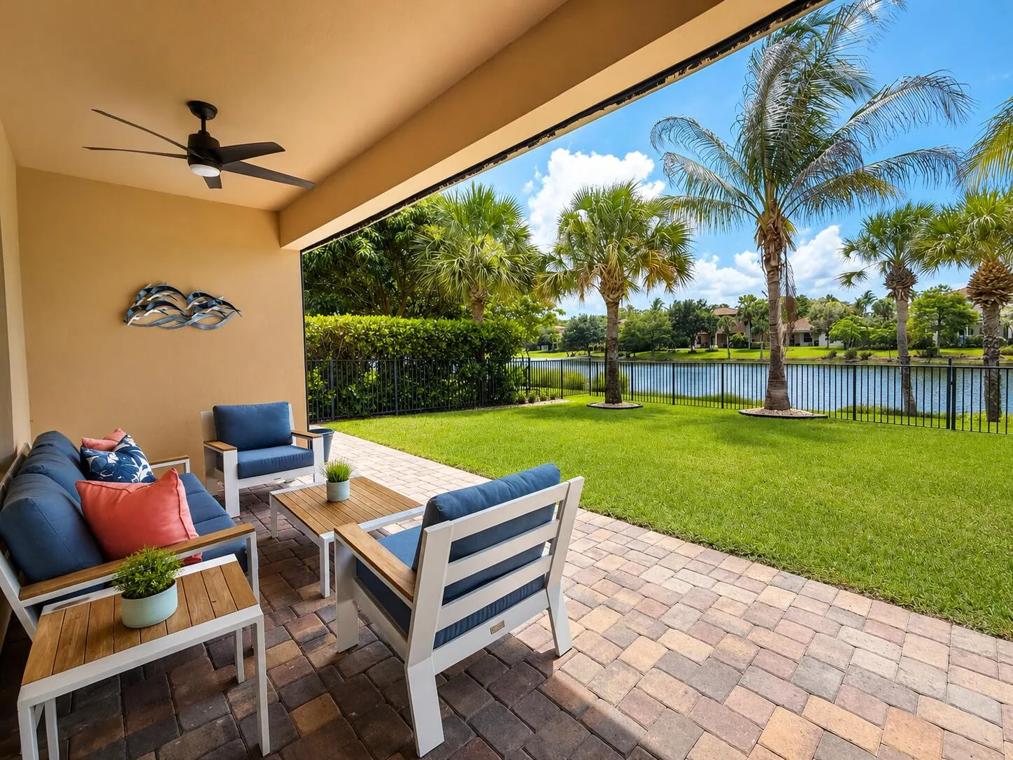 Sunny lakeside patio with tropical backd