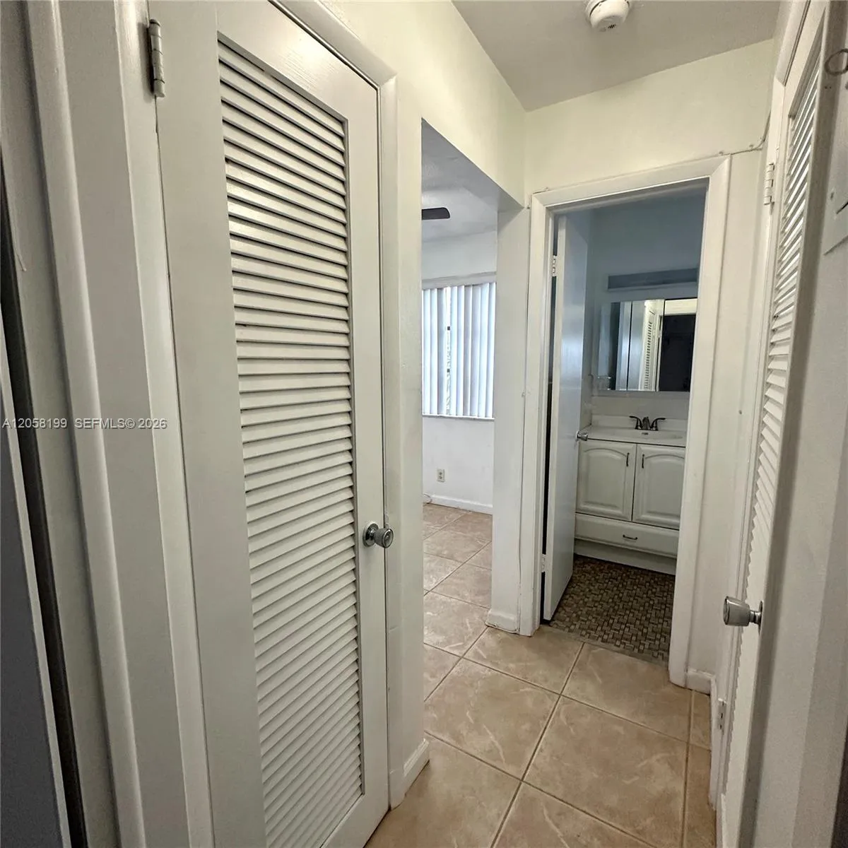 Hallway showing a/c closet, bathroom, dining room to the left