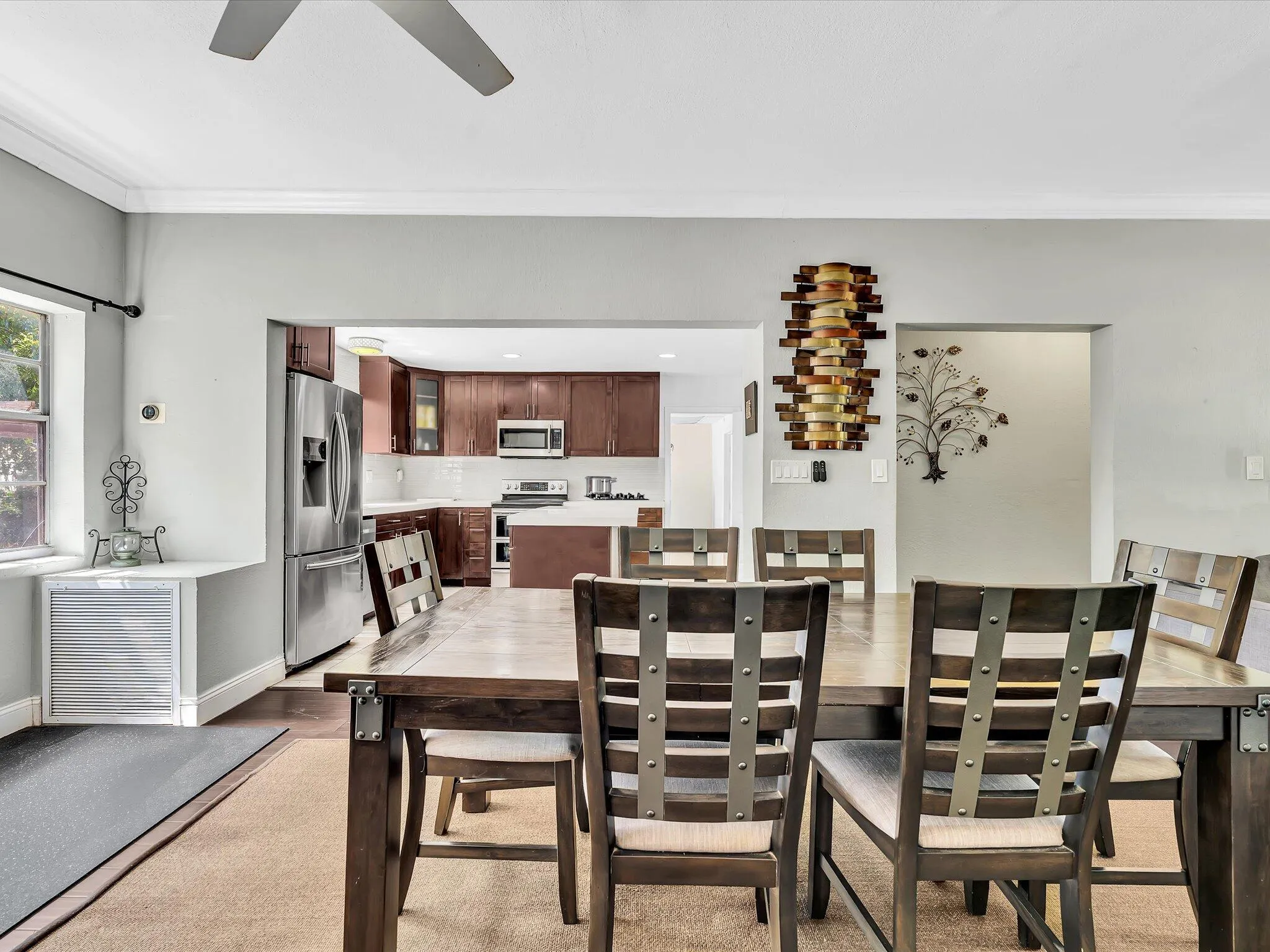 Dining area with light gray walls and crown molding