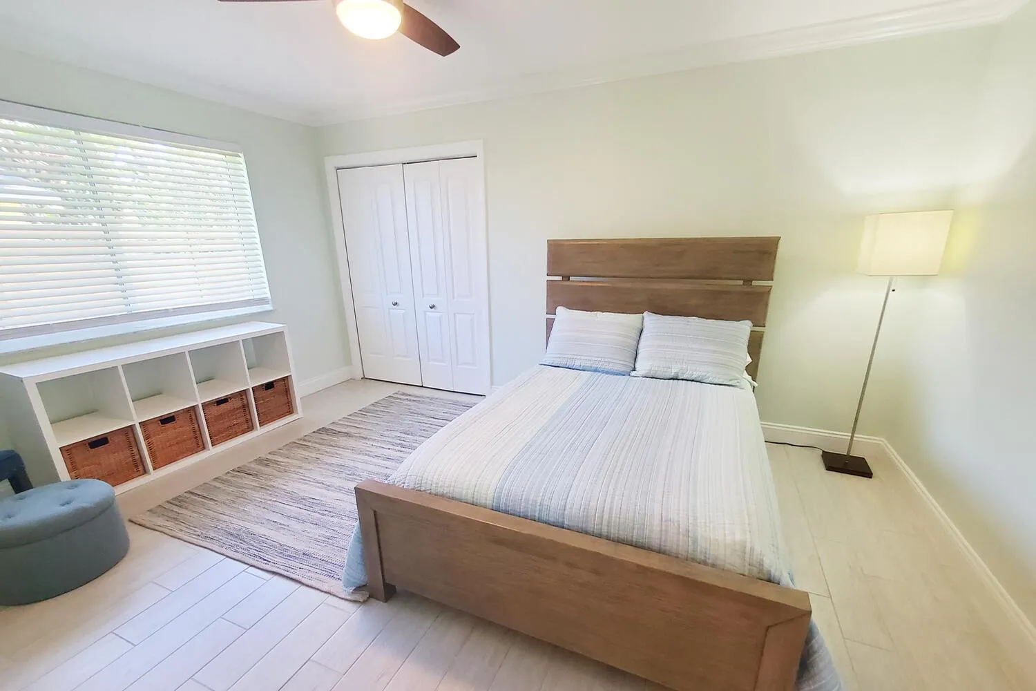 Bedroom 2 featuring light-toned flooring and crown molding