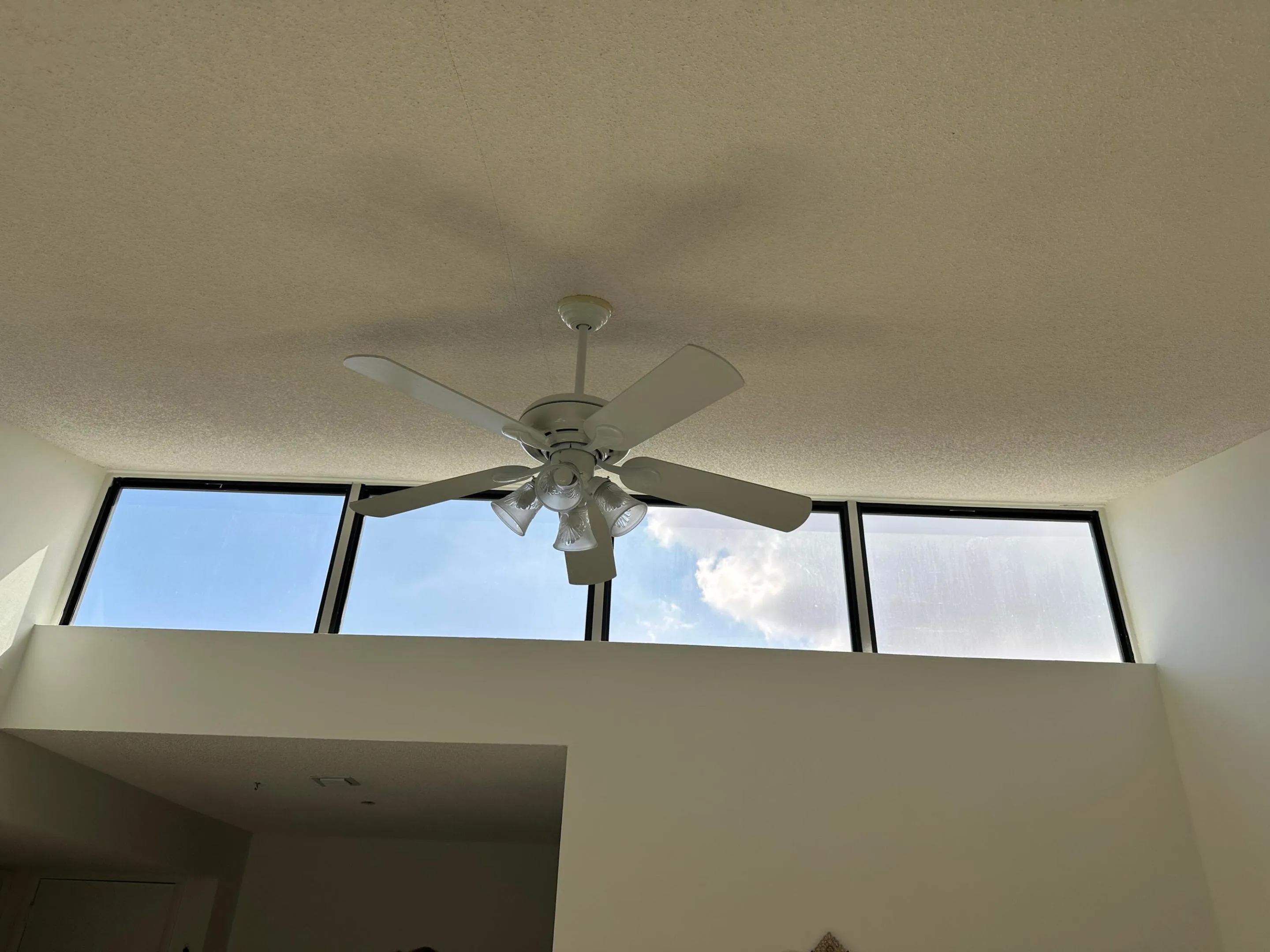 High ceilings with a white ceiling fan and integrated lighting fixture