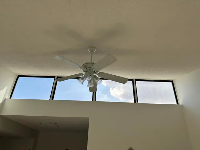 High ceilings with a white ceiling fan and integrated lighting fixture