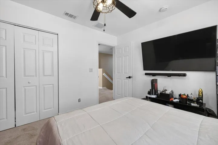 Bedroom featuring white walls and a ceiling fan with integrated lighting