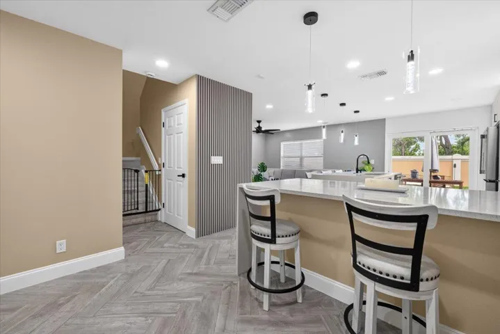 Kitchen island with a light-toned countertop and pendant lighting