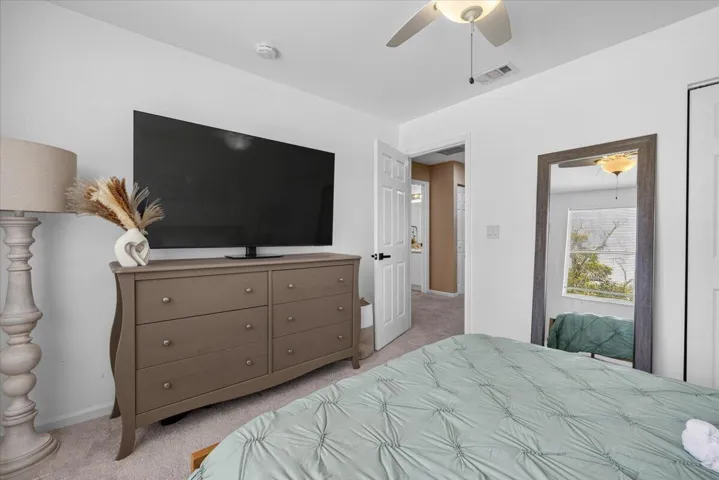 Bedroom featuring light gray carpeting and white walls