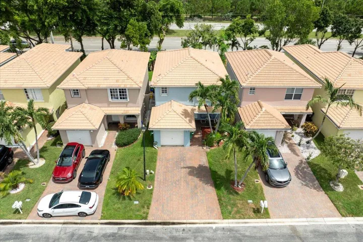 Residential property featuring a Mediterranean-style roof, single-car garage, and a paver driveway