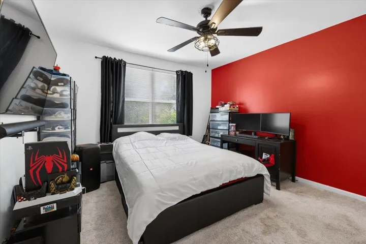 Bedroom featuring carpet flooring and a ceiling fan with integrated lighting