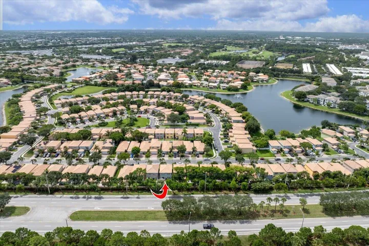 Aerial community overview featuring a large water body with surrounding residences