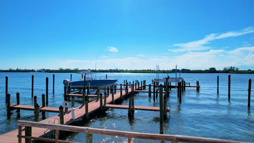 Expansive waterfront property featuring a private boat dock with multiple slips, including a boat lift