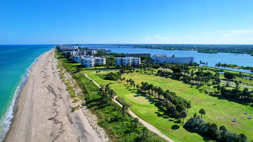 Coastal properties fronting a sandy beach with turquoise ocean waters