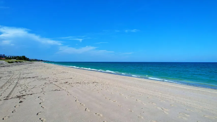 Expansive sandy beach bordered by turquoise ocean waters