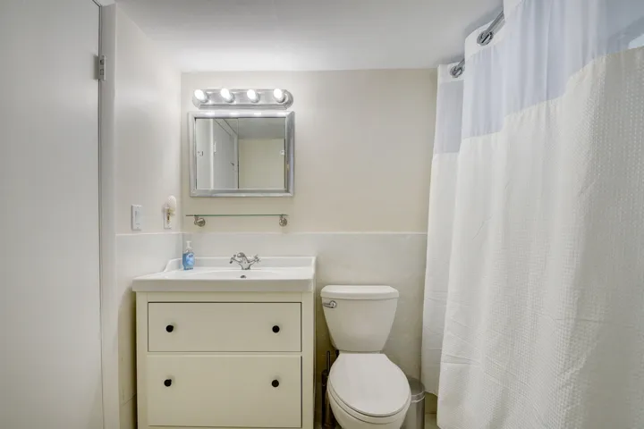 Bathroom featuring a vanity with integrated sink, wall-mounted mirror, and overhead light fixture