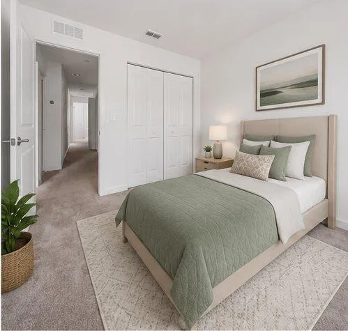 Bedroom featuring neutral carpeting, white walls, and a closet