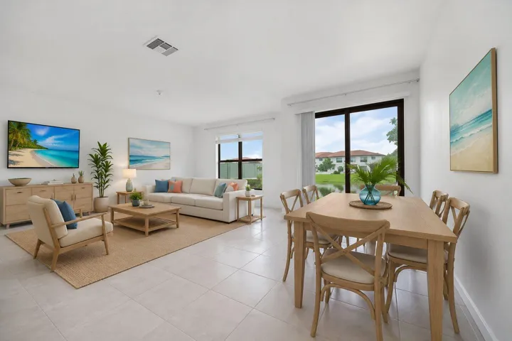 Open-concept living and dining area featuring tile flooring, white walls, and abundant natural light