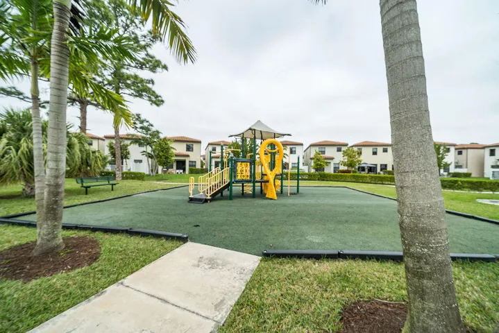 Expansive recreation area featuring a playground with slides and climbing elements