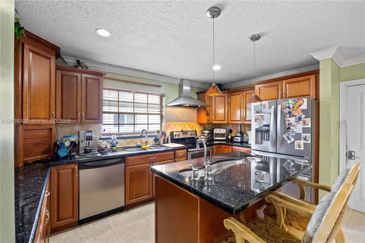 Kitchen with granite top counters.