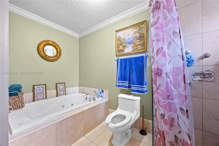 Master bathroom with Jacuzzi tub and standing shower.