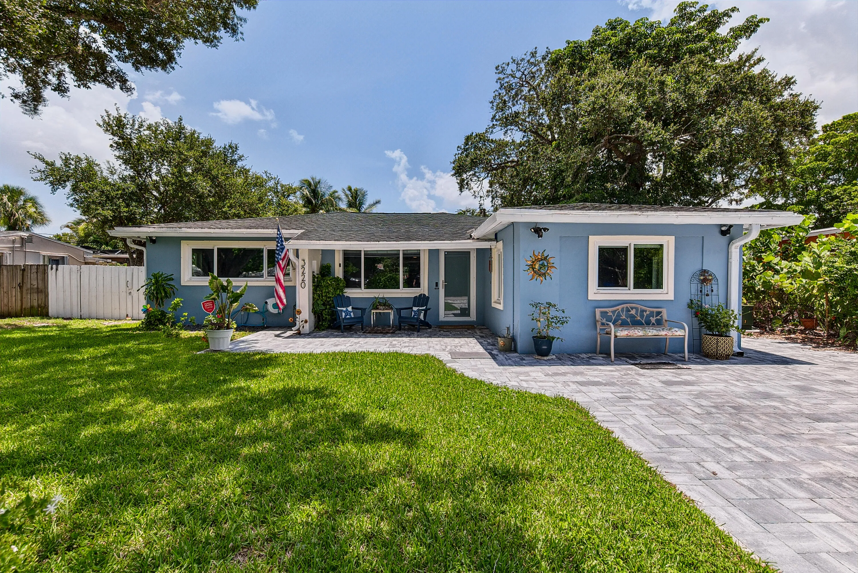 Front of home with beautiful paver patio entrance, walkway and driveway