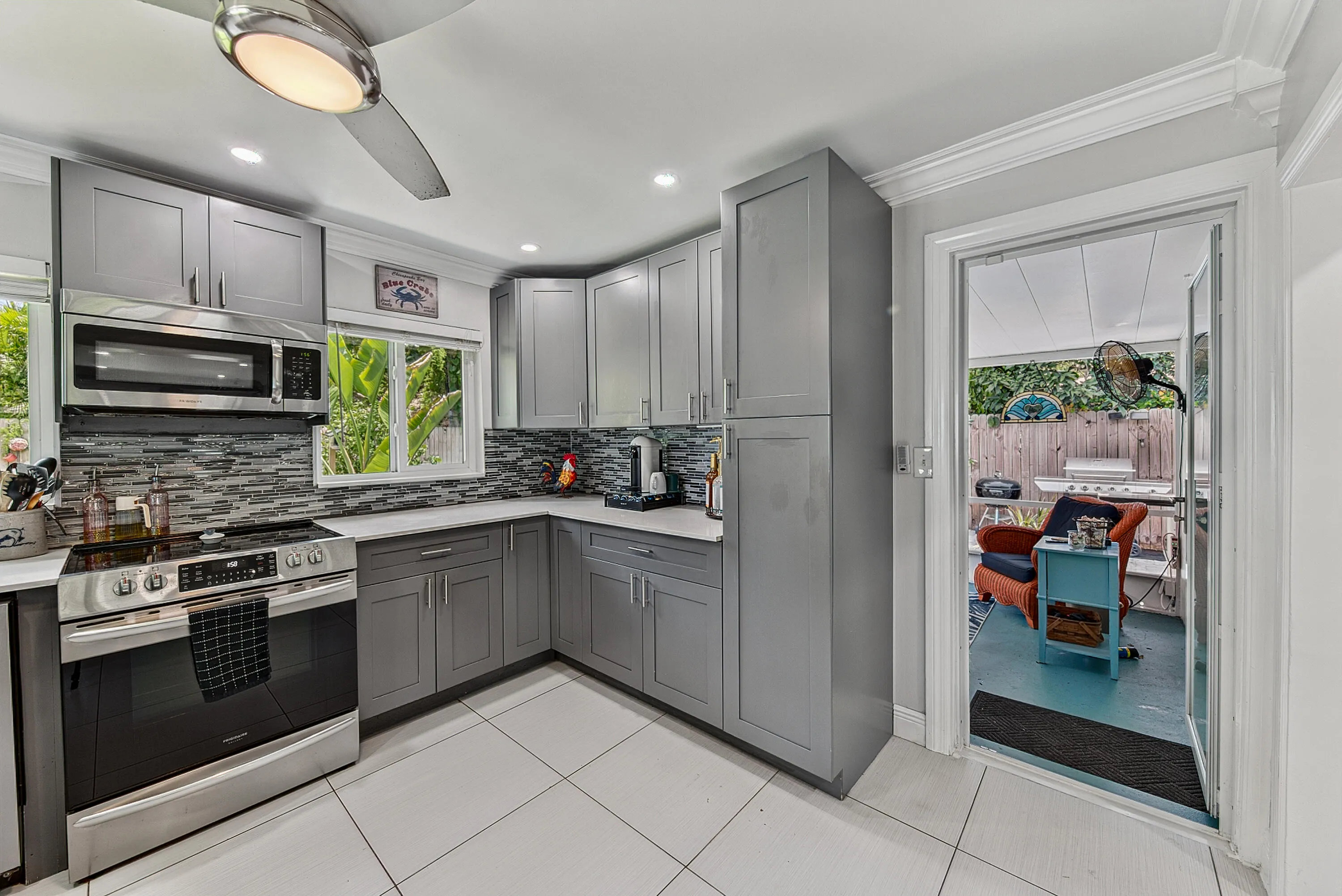 Kitchen with view into back screened patio