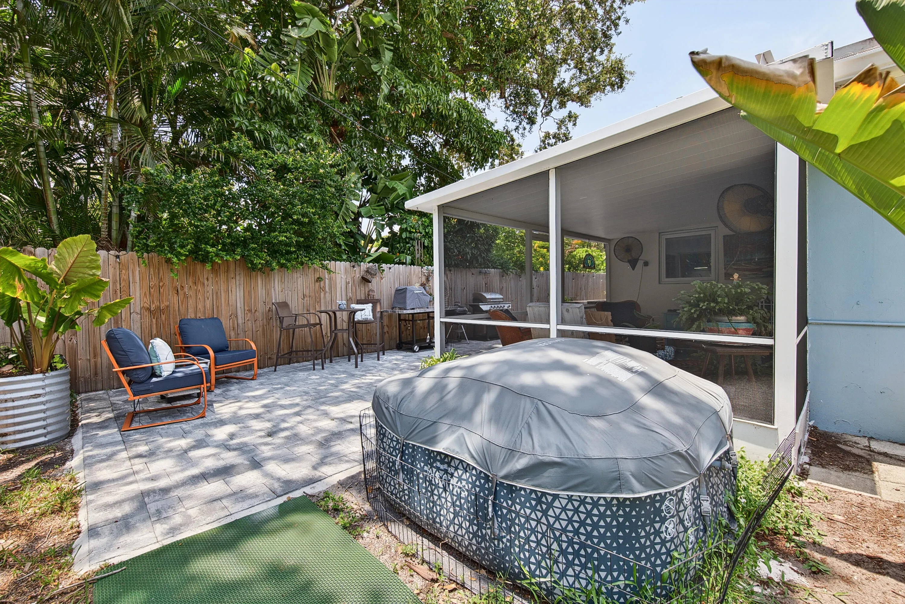 Hot tub in back yard and adjacent to screened back patio