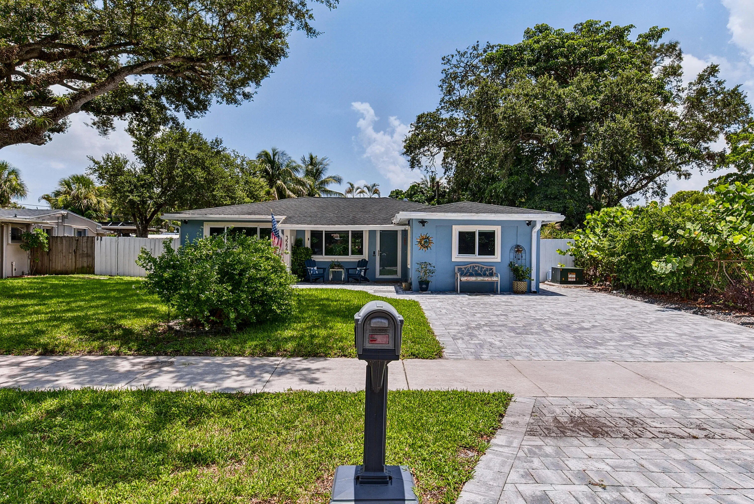 Front of home with paver driveway and front patio